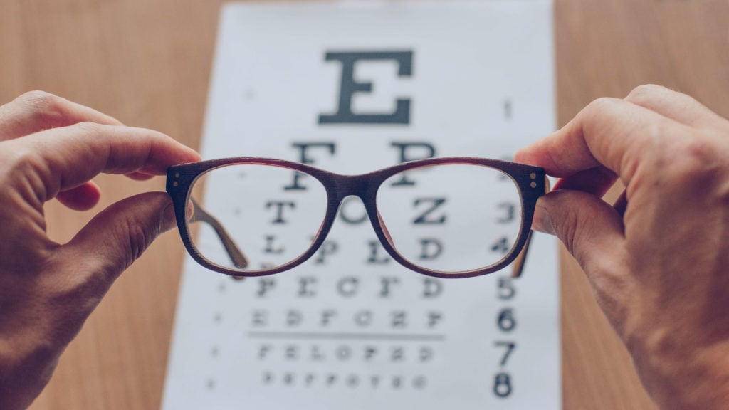 Eyeglasses in front of an eye chart ophthalmic technician medical eye center