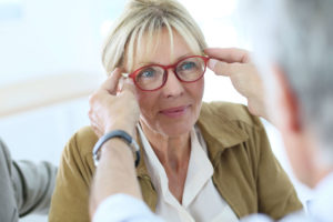 Woman getting glasses from an eye doctor